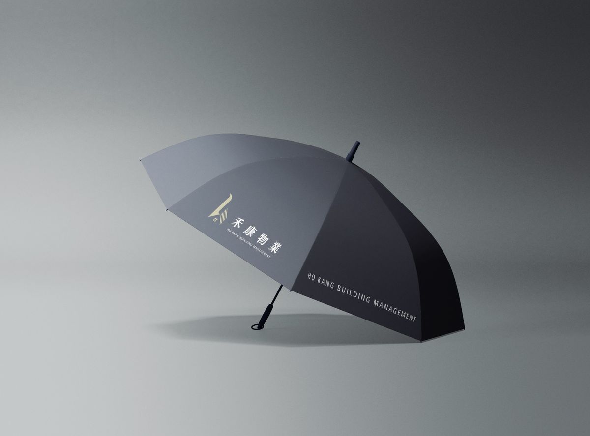 深灰色長柄傘，傘面印著禾康物業 logo 與英文名稱